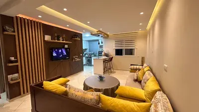 a living room with a couch and a table at Modern apartment in Skhirat 5 minutes from the beach in Skhirat
