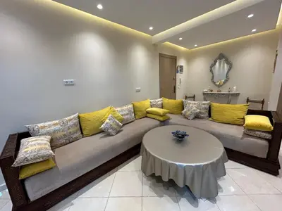 a living room with a couch and a table at Modern apartment in Skhirat 5 minutes from the beach in Skhirat