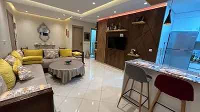 a living room with a couch and a table at Modern apartment in Skhirat 5 minutes from the beach in Skhirat