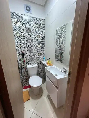 a bathroom with a toilet and a sink at Modern apartment in Skhirat 5 minutes from the beach in Skhirat