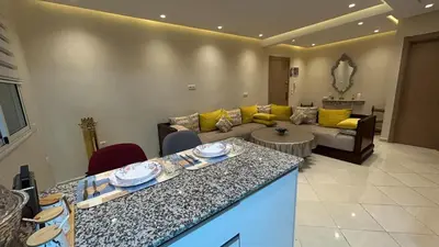 a living room with a couch and a table at Modern apartment in Skhirat 5 minutes from the beach in Skhirat