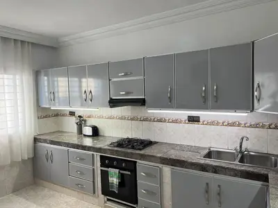 a kitchen with stainless steel cabinets and a sink at Spacious apartment beachfront city center in Casablanca