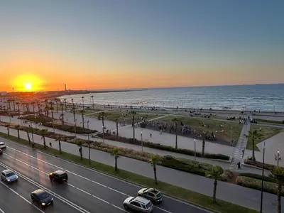 a road with cars on it next to the beach at Spacious apartment beachfront city center in Casablanca