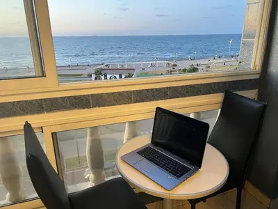 a laptop computer sitting on a table in front of a window at Spacious apartment beachfront city center in Casablanca