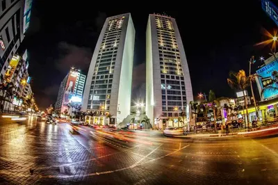 a city street with two tall buildings at night at Spacious apartment beachfront city center in Casablanca