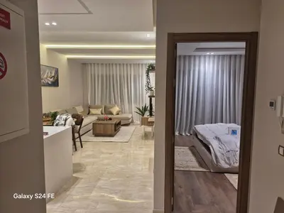a living room with a couch and a table at aeroperla 15 aéroport casa blanca in Nouaseur