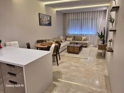 a living room with a couch and a table at aeroperla 15 aéroport casa blanca in Nouaseur