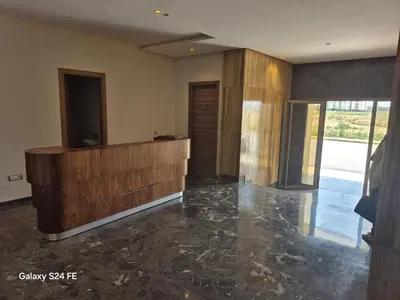 a living room with a wood paneled wall at aeroperla 15 aéroport casa blanca in Nouaseur