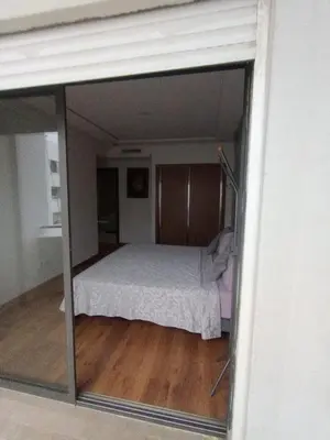 a view of a bedroom through a glass window at Appart Haut Standing, Très Calm à Nouaceur, Parking, Piscine, à 4min de l'Aéroport in Casablanca