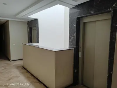 an empty room with a white wall and two doors at Appart Haut Standing, Très Calm à Nouaceur, Parking, Piscine, à 4min de l'Aéroport in Casablanca