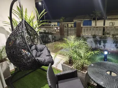 a hammock chair on a balcony with a table at Rita in Mohammedia