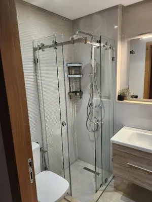 a bathroom with a shower and a toilet and a sink at Rita in Mohammedia