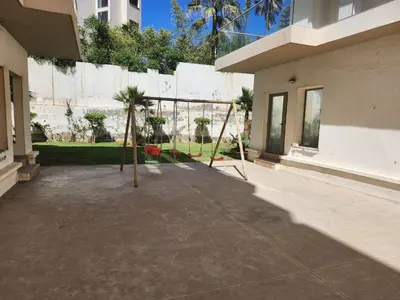 a courtyard with swings in a building at Rita in Mohammedia