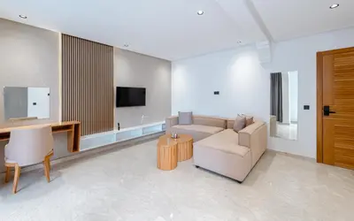 a living room with a couch and a tv at Spinoza House Suite de luxe Casablanca - Maarif in Casablanca