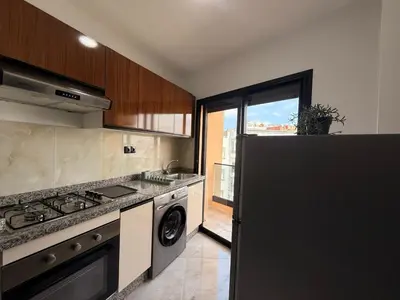 a kitchen with a stove and a sink and a dishwasher at Elegance & Comfort - by Nero in Casablanca