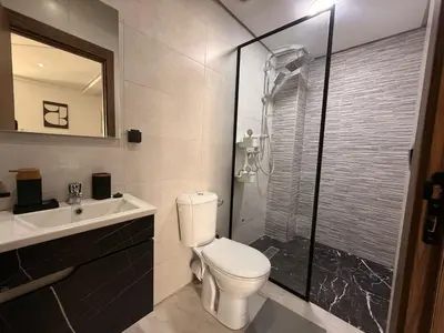 a bathroom with a toilet and a shower and a sink at Elegance & Comfort - by Nero in Casablanca