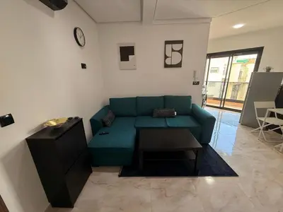 a living room with a green couch and a table at Elegance & Comfort - by Nero in Casablanca