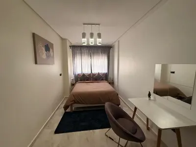 a bedroom with a bed and a desk and a mirror at Urban Loft - by Nero in Casablanca