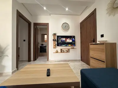 a living room with a tv on a wall at Urban Loft - by Nero in Casablanca