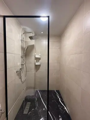 a shower with a glass door in a bathroom at Urban Loft - by Nero in Casablanca
