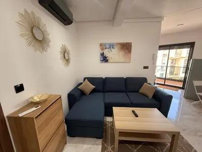a living room with a blue couch and a table at Urban Loft - by Nero in Casablanca