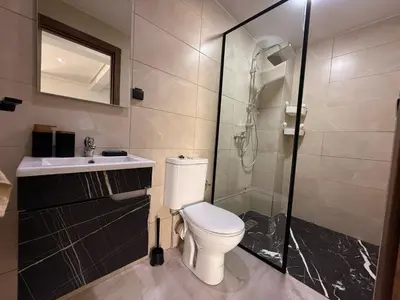 a bathroom with a toilet and a shower and a sink at Urban Loft - by Nero in Casablanca