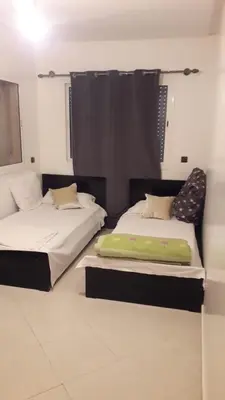 two beds sitting next to each other in a room at Chez Fatima - Nassim Gh12 in Mohammedia