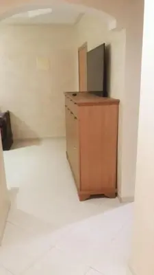 an empty room with a desk with a television on it at Chez Fatima - Nassim Gh12 in Mohammedia