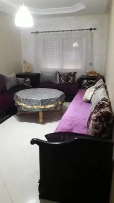 a living room with a bed and a couch at Chez Fatima - Nassim Gh12 in Mohammedia