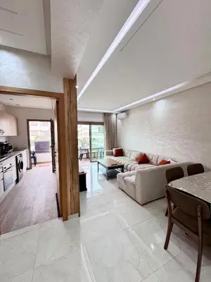 a living room with a couch and a table at Residence Garden Paradise plage luxe in Bouznika