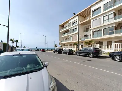a row of cars parked in front of a building at L'Écume Des Sablettes in Mohammedia