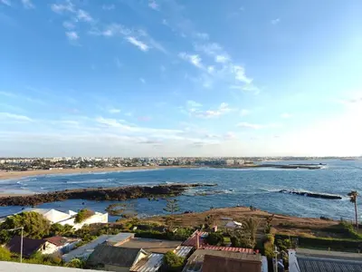a view of a body of water with a city at Appart Moderne Vue mer latérale & piscine - Plage des Sablettes El Mansouria in O Ben Slimane