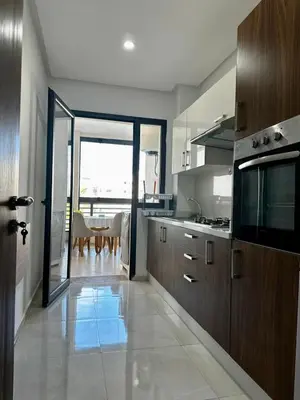 a large kitchen with a table and a dining room at APT Luxueux à Costa Beach 3 avec Piscine et accès Plage in Bouznika