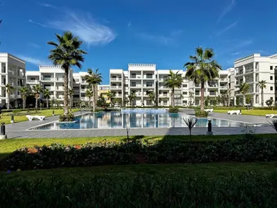a large apartment building with a large swimming pool at APT Luxueux à Costa Beach 3 avec Piscine et accès Plage in Bouznika