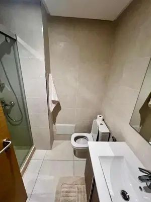 a bathroom with a toilet and a sink and a shower at CAN STADIUM VIEW Luxurious Place Prestigia Hay Riad in Rabat