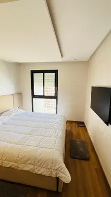 a bedroom with a large bed and a window at CAN STADIUM VIEW Luxurious Place Prestigia Hay Riad in Rabat