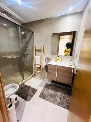 a bathroom with a shower and a sink and a toilet at CAN STADIUM VIEW Luxurious Place Prestigia Hay Riad in Rabat