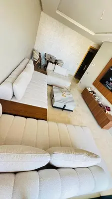 a living room with white furniture and a couch at CAN STADIUM VIEW Luxurious Place Prestigia Hay Riad in Rabat