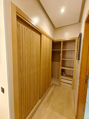 a walk in closet with wooden panels and a door at L'Écume des Sablettes in Mansouria