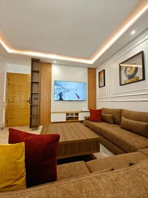 a living room with a couch and a table at L'Écume des Sablettes in Mansouria