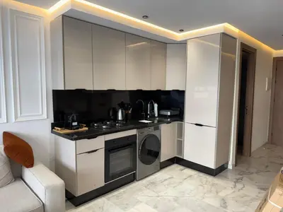 a kitchen with white cabinets and a stove top oven at Joli Studio with Seaview 16 in Casablanca