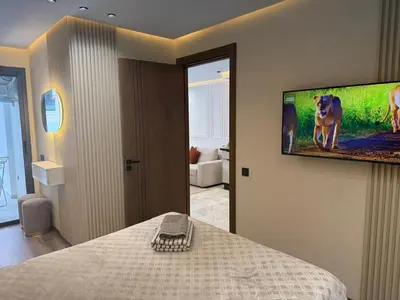 a bedroom with a tv hanging on the wall at Joli Studio with Seaview 16 in Casablanca