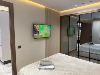 a bedroom with a bed and a tv on the wall at Joli Studio with Seaview 16 in Casablanca