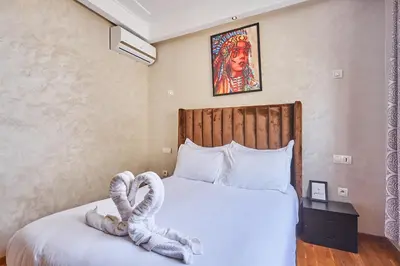 a bedroom with a large white bed with at 2BR Getaway Near and Seaside Promenade in Casablanca