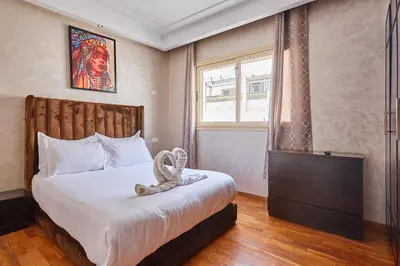 a bedroom with a bed and a window and a bed sidx sidx sidx at 2BR Getaway Near and Seaside Promenade in Casablanca