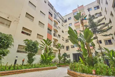 a building with trees and plants in front of it at 2BR Getaway Near and Seaside Promenade in Casablanca