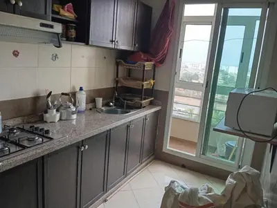 a kitchen with a sink and a stove and a window at Sara Appartement in Casablanca