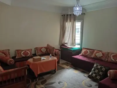 a living room with couches and a table at Sara Appartement in Casablanca