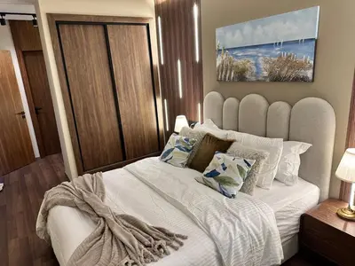 a bedroom with a large white bed with pillows at Harmonie Elitaire in Casablanca