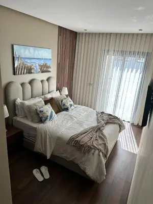 a bedroom with a large bed with two pillows at Harmonie Elitaire in Casablanca